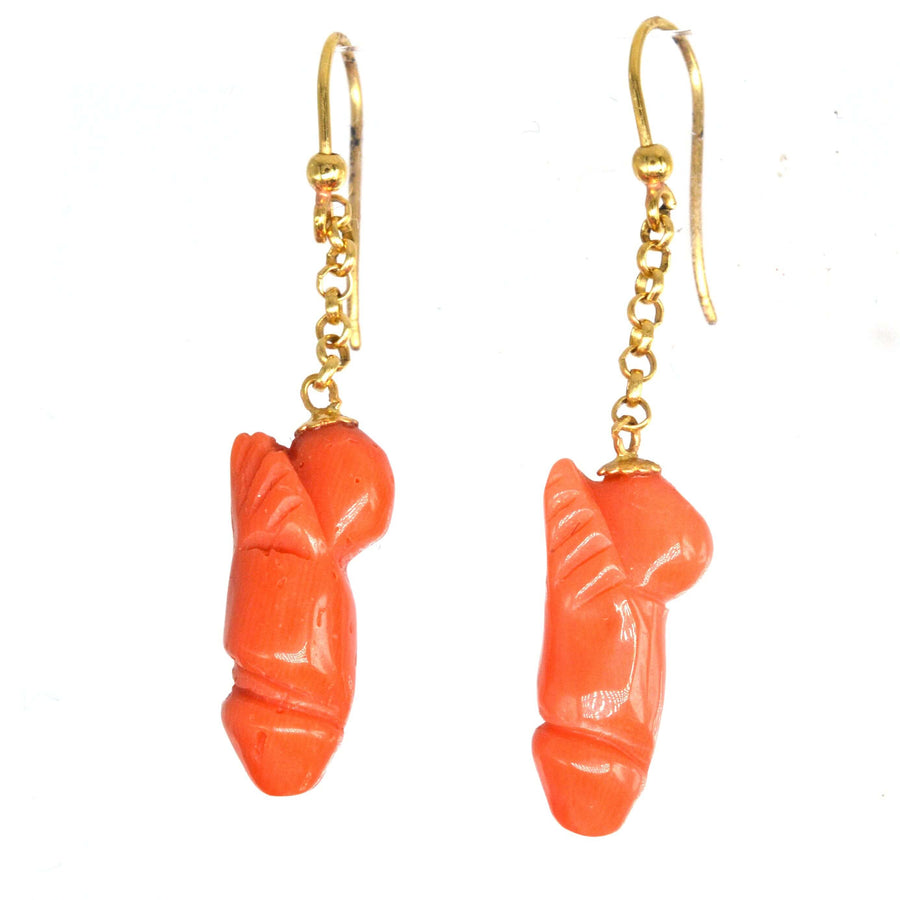 Vintage 18ct gold drop earrings with carved coral phallus pendants, symbolizing fertility and good fortune.