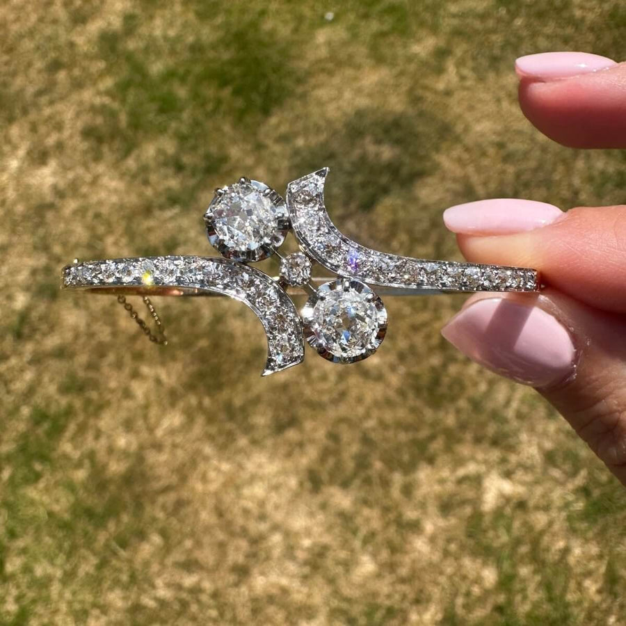 French 20th century 18ct gold and platinum Toi et Moi diamond bangle with two large diamonds.