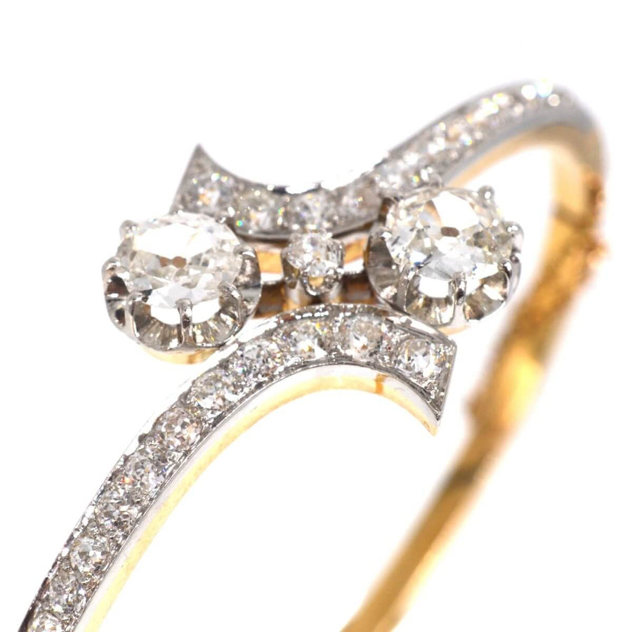 Early 20th century diamond Toi et Moi bangle in 18ct gold and platinum, showcasing exquisite craftsmanship.