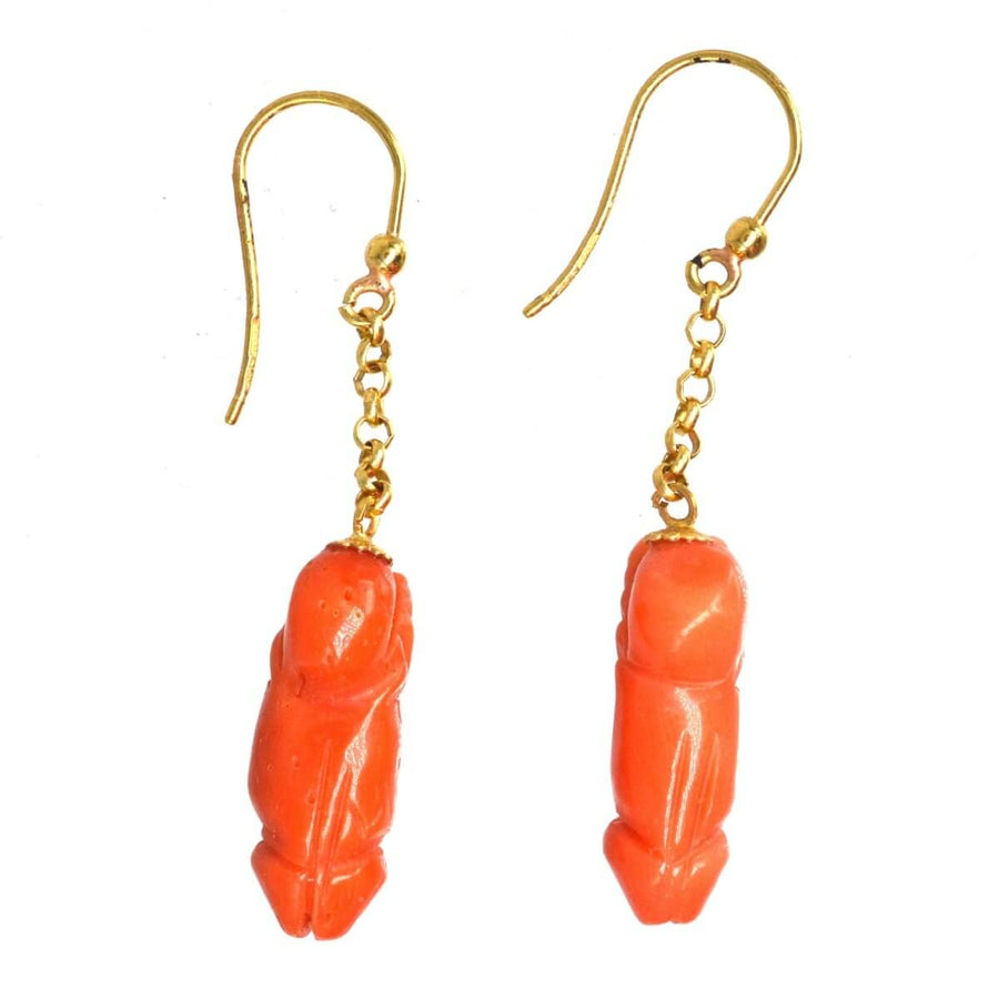 Vintage 18ct gold drop earrings with carved coral phallus design, symbolizing fertility and good fortune.
